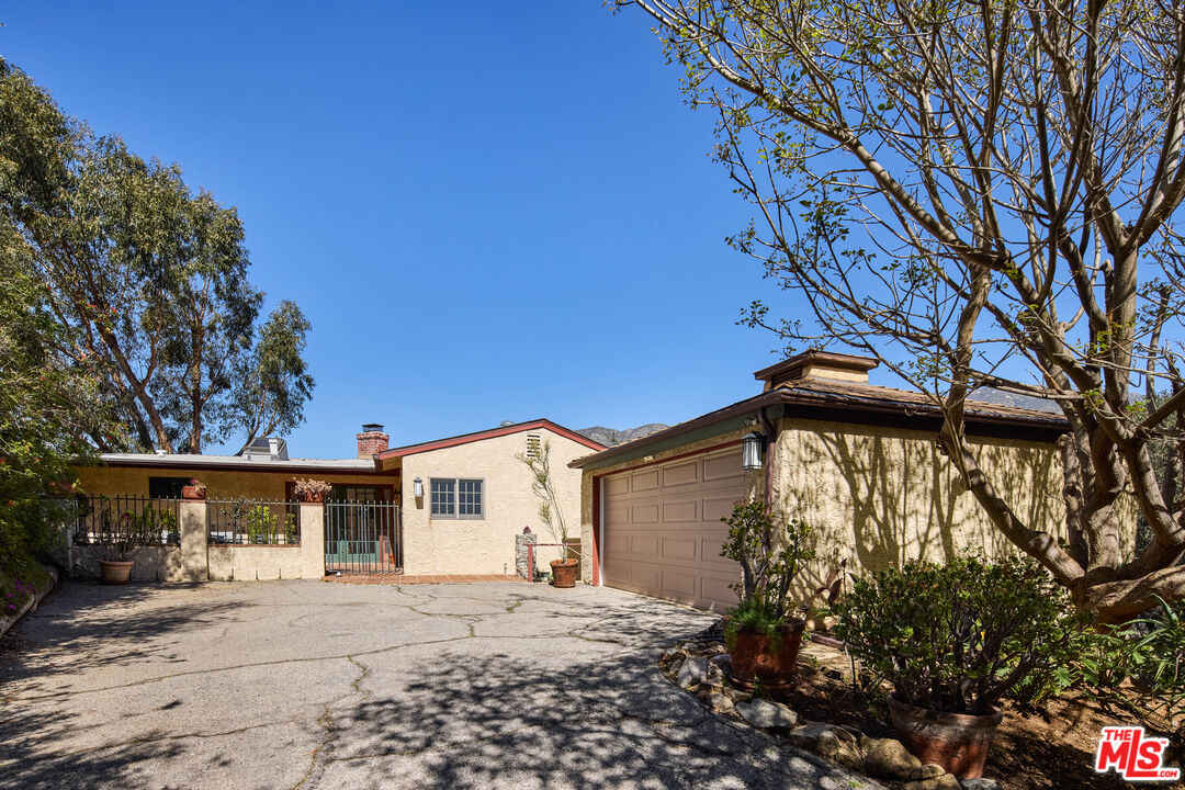6948 St Estaban Street Tujunga, CA 91042 - Photo 2 of 26 a front view of a house with a yard