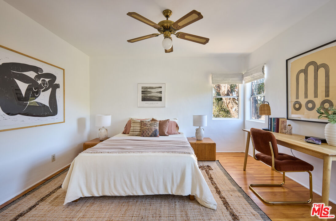 6948 St Estaban Street Tujunga, CA 91042 - Photo 21 of 26 a bedroom with a bed and wooden floor