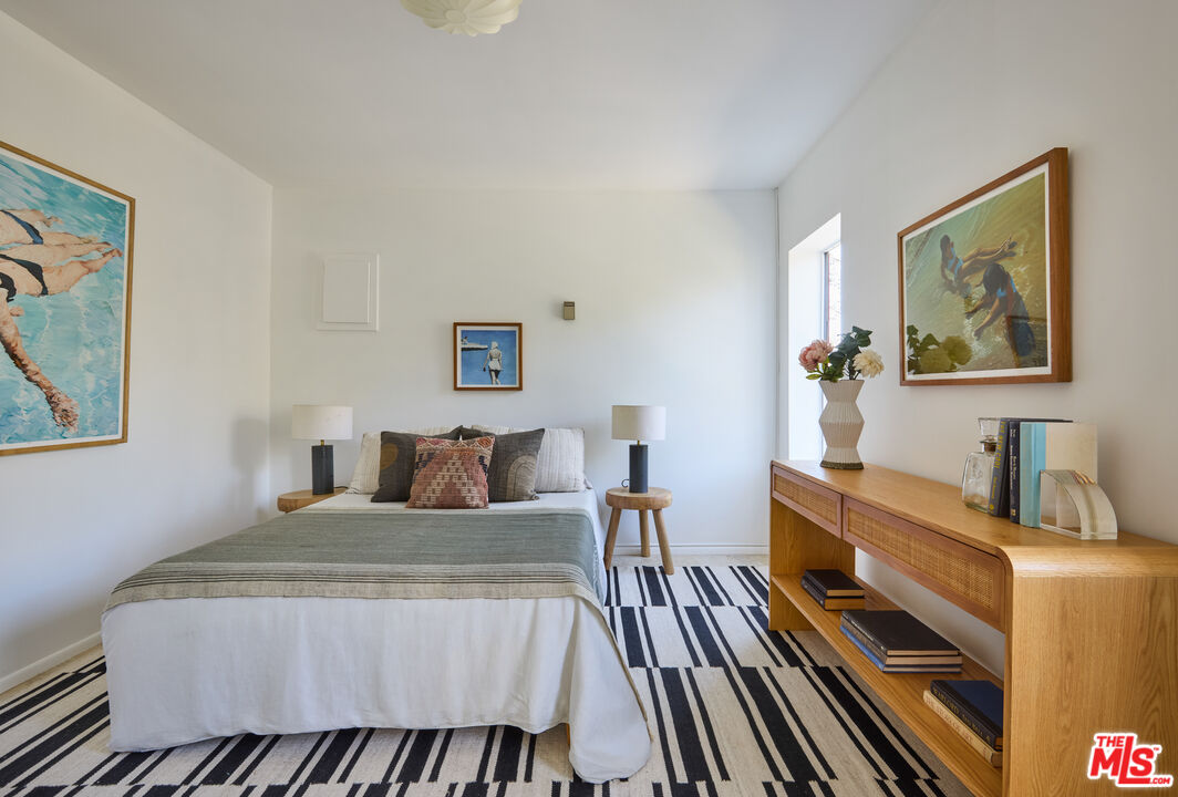 6948 St Estaban Street Tujunga, CA 91042 - Photo 23 of 26 a bedroom with a bed and a desk