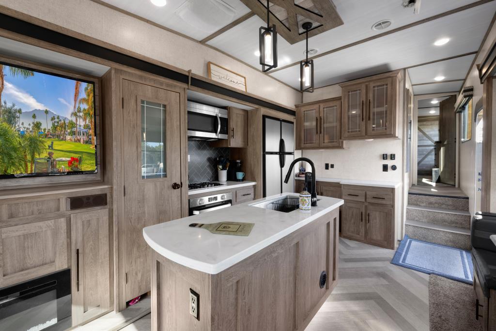 69411 Ramon Road, Unit 502 Cathedral City, CA 92234 - Photo 17 of 23 a kitchen with stainless steel appliances granite countertop a sink and a refrigerator