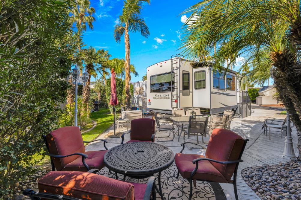 69411 Ramon Road, Unit 502 Cathedral City, CA 92234 - Photo 6 of 23 a view of a patio with table and chairs and potted plants