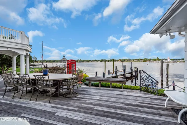 a living room with furniture a wooden floor and a large window