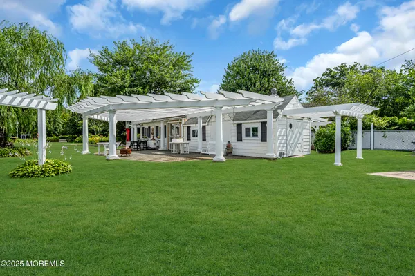 an aerial view of a house with a yard and lake view