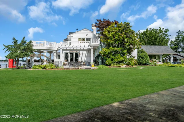 a view of staircase with lots of frames on wall and a window