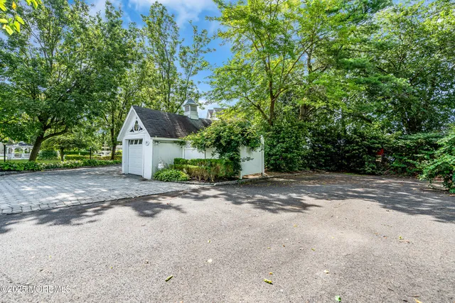 a view of a roof deck with table and chairs a barbeque with wooden floor and fence