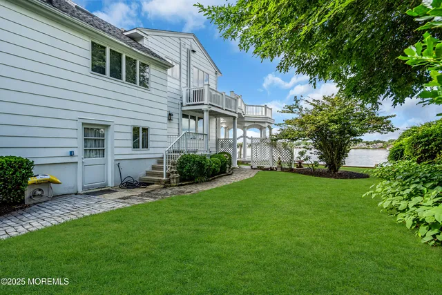 a front view of a house with a garden and trees