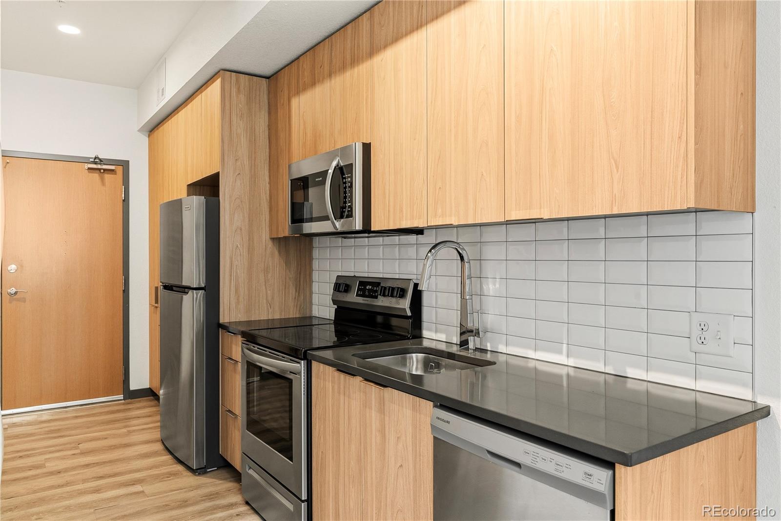 603 Inca Street, Unit 330 Denver, CO 80204 - Photo 14 of 18 a kitchen with stainless steel appliances a sink stove and cabinets