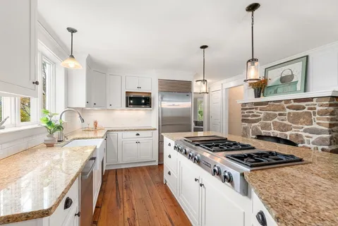 a kitchen with stove cabinets and refrigerator