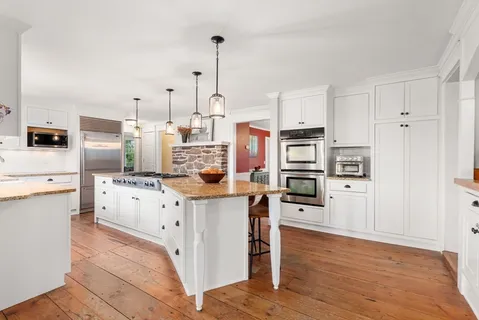 a kitchen with stainless steel appliances and white cabinets