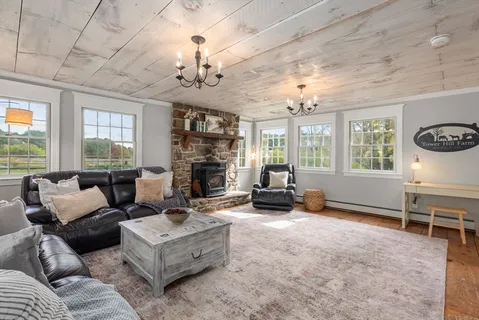 a living room with furniture chandelier and a fireplace