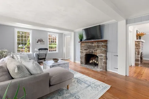 a living room with furniture a flat screen tv and a fireplace