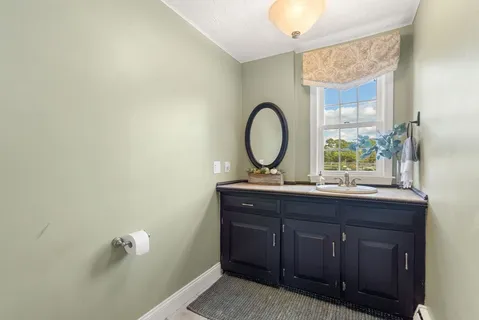 a room with a sink mirror and vanity