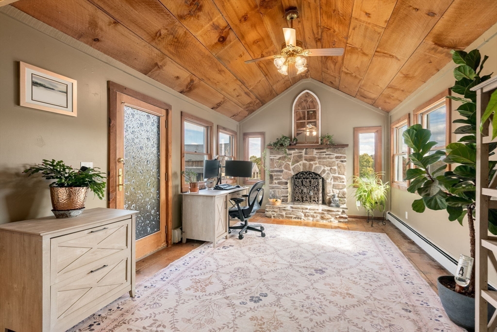 50 Tower Hill Road Brimfield, MA 01010 - Photo 24 of 40 a view of a livingroom with a fireplace a chandelier and windows