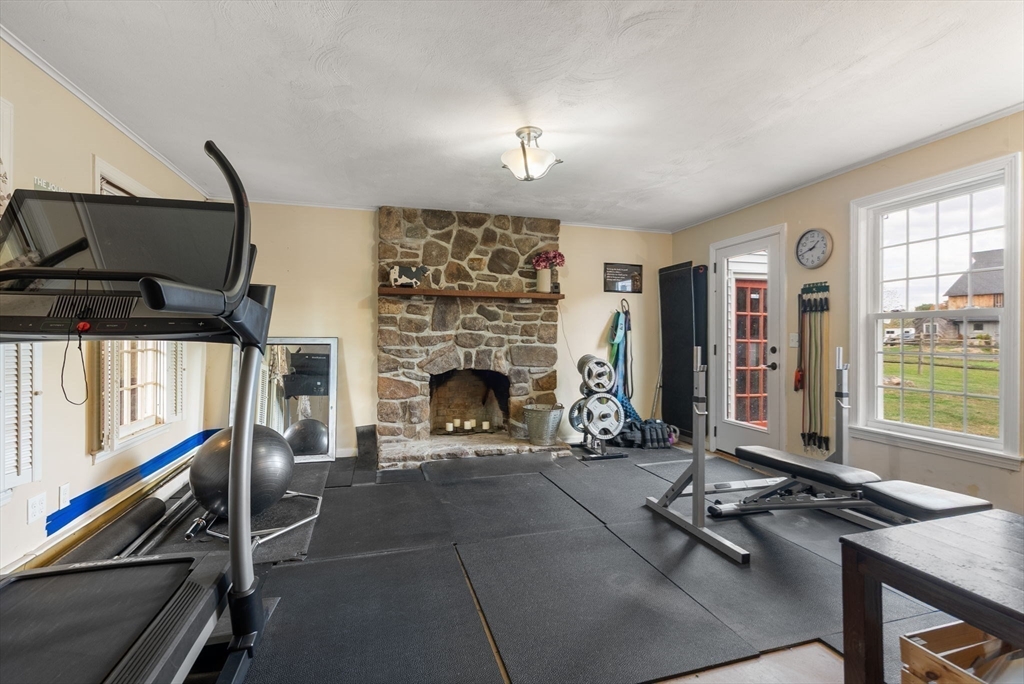 50 Tower Hill Road Brimfield, MA 01010 - Photo 30 of 40 a living room with furniture a fireplace and a flat screen tv
