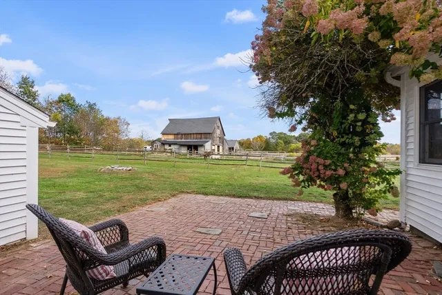 a view of a backyard with sitting area