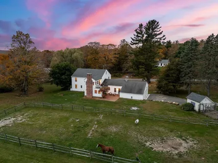 a backyard of a house with table and chairs