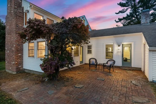 a view of a house with backyard and sitting area