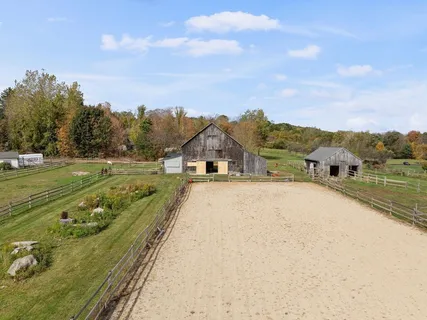 aerial view of a house with a yard and lake view