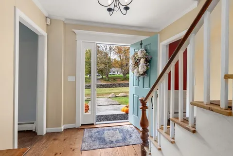 a view of entryway with wooden floor and stairs
