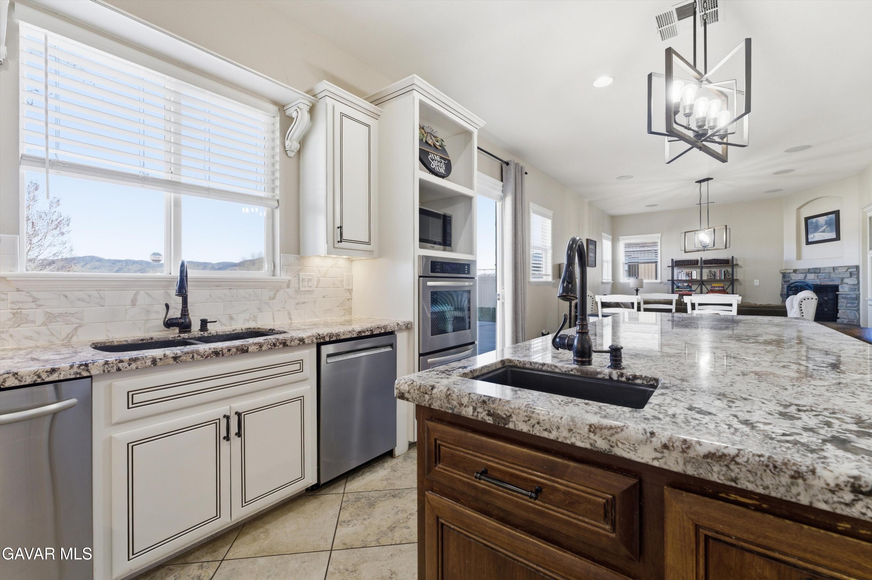 109 Oak Place Tehachapi, CA 93561 - Photo 12 of 25 a kitchen with stainless steel appliances granite countertop a sink a stove and cabinets