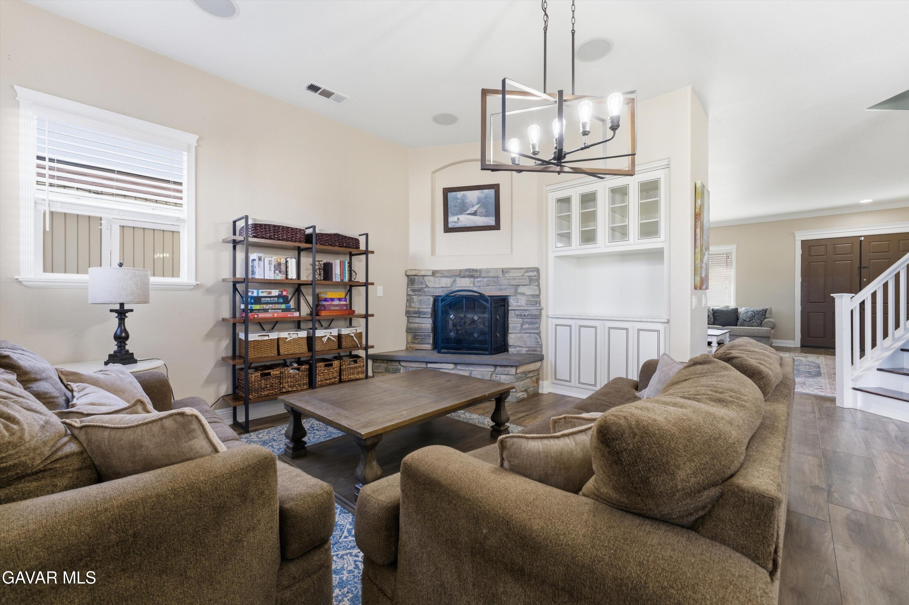 109 Oak Place Tehachapi, CA 93561 - Photo 15 of 25 a living room with furniture a flat screen tv and a fireplace