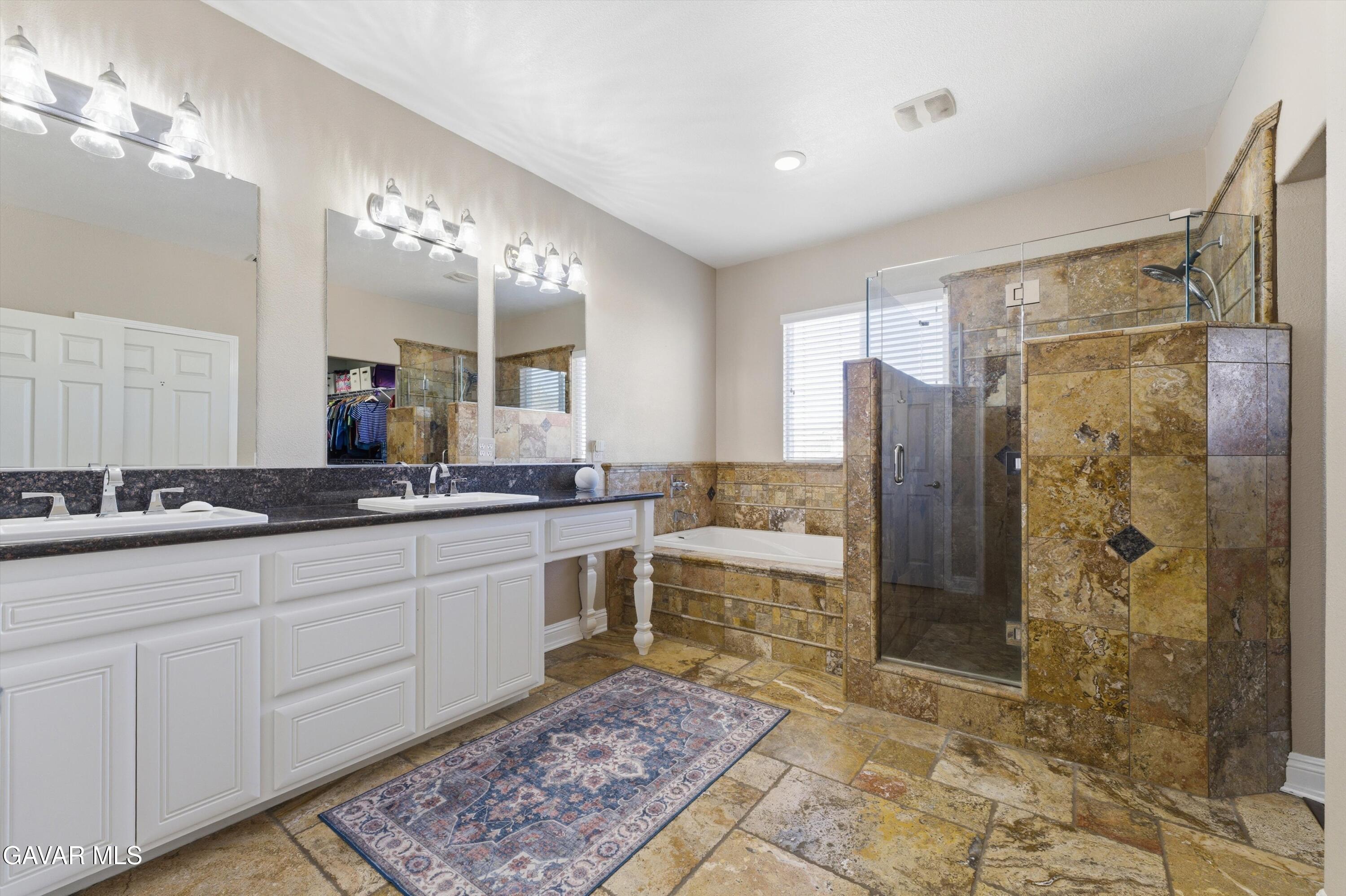 109 Oak Place Tehachapi, CA 93561 - Photo 20 of 25 a bathroom with a double vanity sink a mirror and a shower