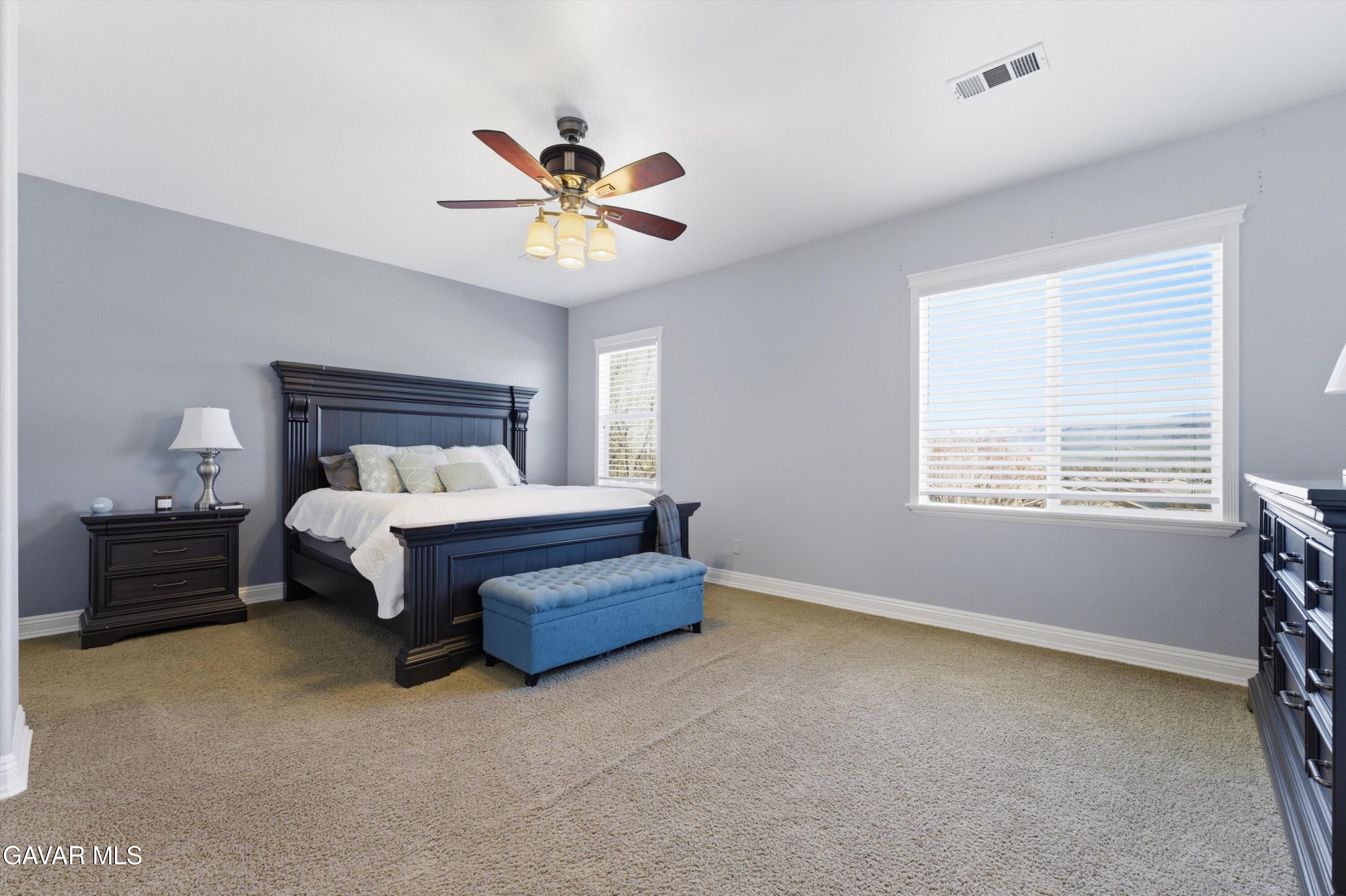 109 Oak Place Tehachapi, CA 93561 - Photo 2 of 25 a bedroom with a bed and a chandelier