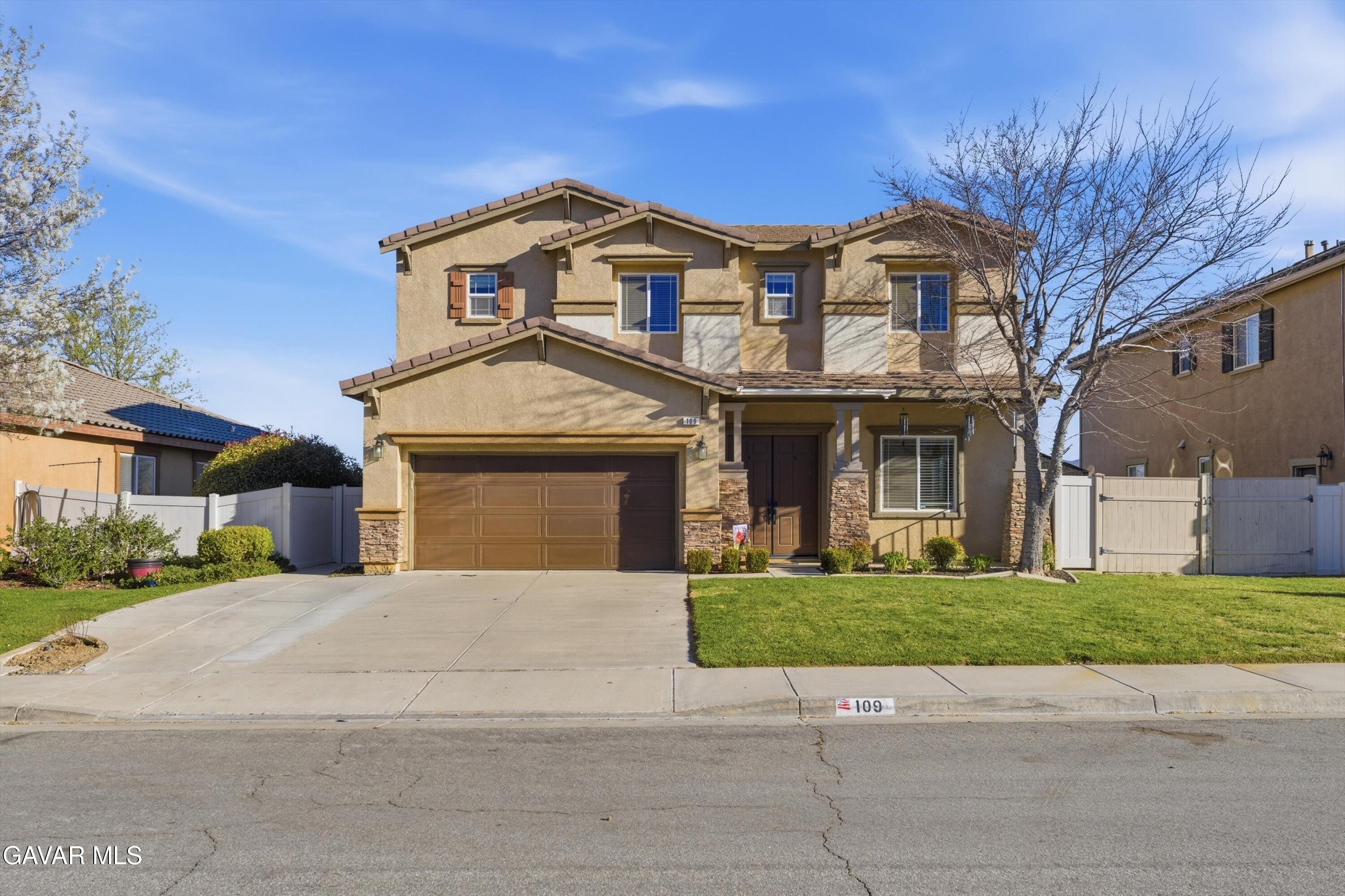 109 Oak Place Tehachapi, CA 93561 - Photo 7 of 25 a front view of a house with a garden and trees