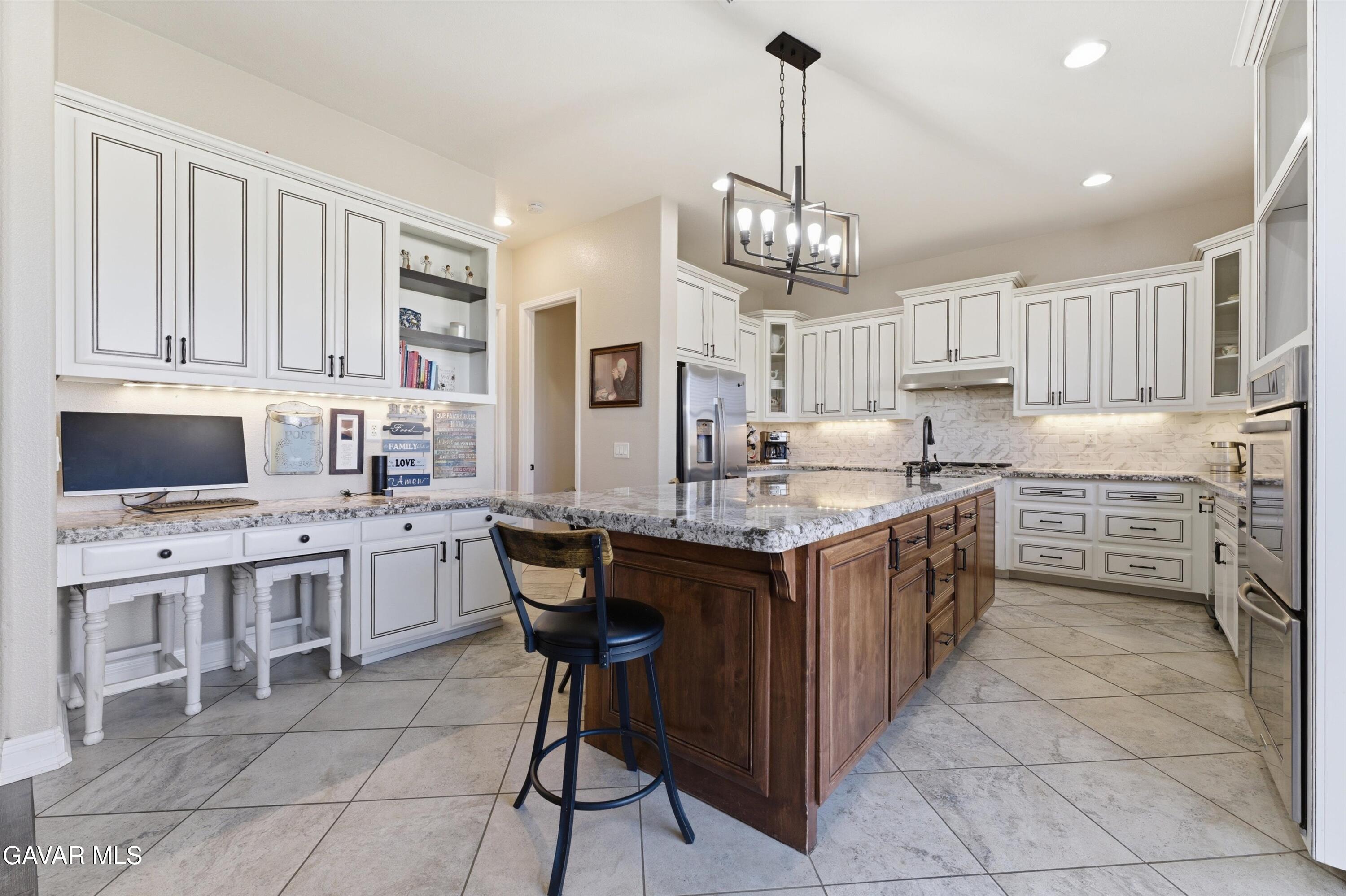 109 Oak Place Tehachapi, CA 93561 - Photo 10 of 25 a kitchen with kitchen island granite countertop a sink counter top space appliances and cabinets