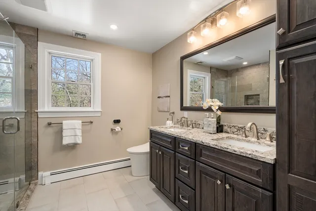 a bathroom with a granite countertop sink mirror and double