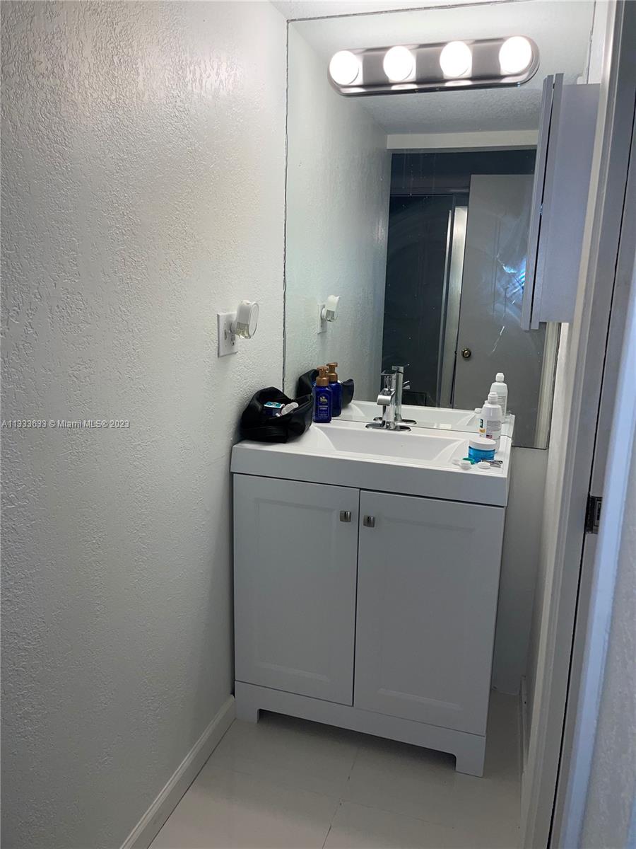 9500 Southwest 3rd Street, Unit C258 Boca Raton, FL 33428 - Photo 11 of 13 a bathroom with a sink and a mirror