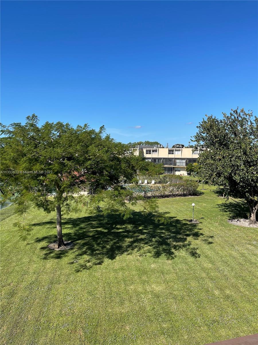 9500 Southwest 3rd Street, Unit C258 Boca Raton, FL 33428 - Photo 13 of 13 a view of a pool with a yard