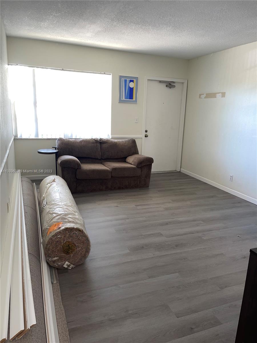 9500 Southwest 3rd Street, Unit C258 Boca Raton, FL 33428 - Photo 3 of 13 a living room with furniture and a window