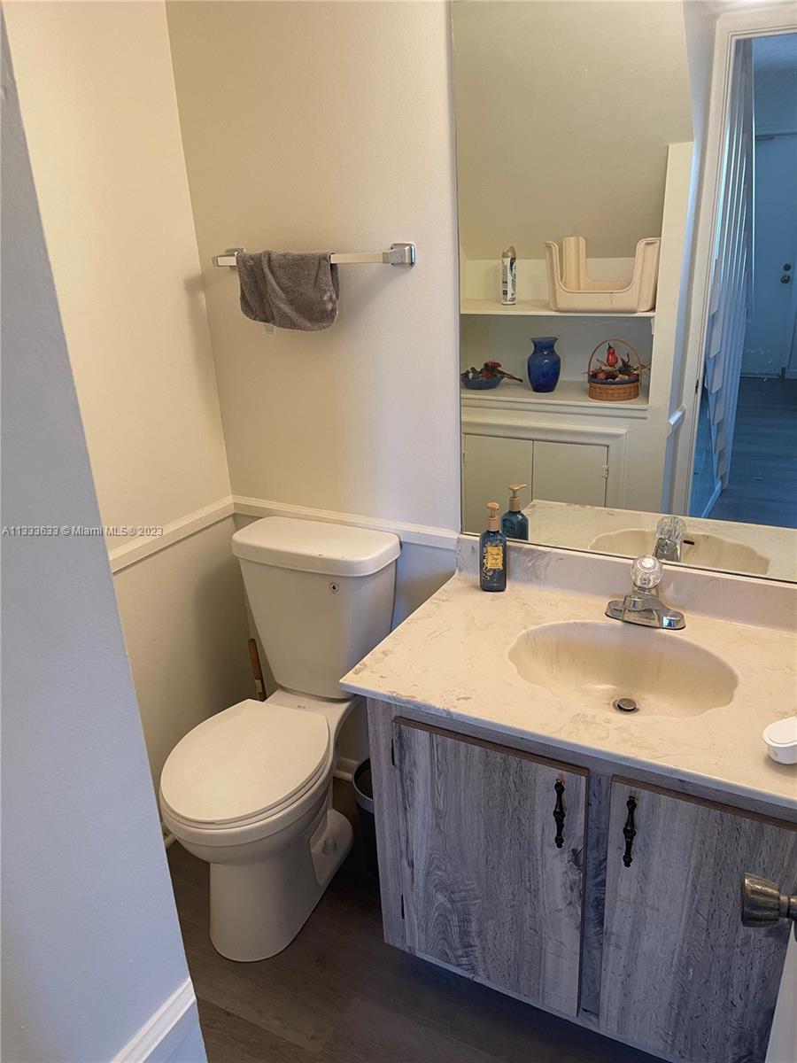 9500 Southwest 3rd Street, Unit C258 Boca Raton, FL 33428 - Photo 4 of 13 a bathroom with a granite countertop toilet sink and mirror
