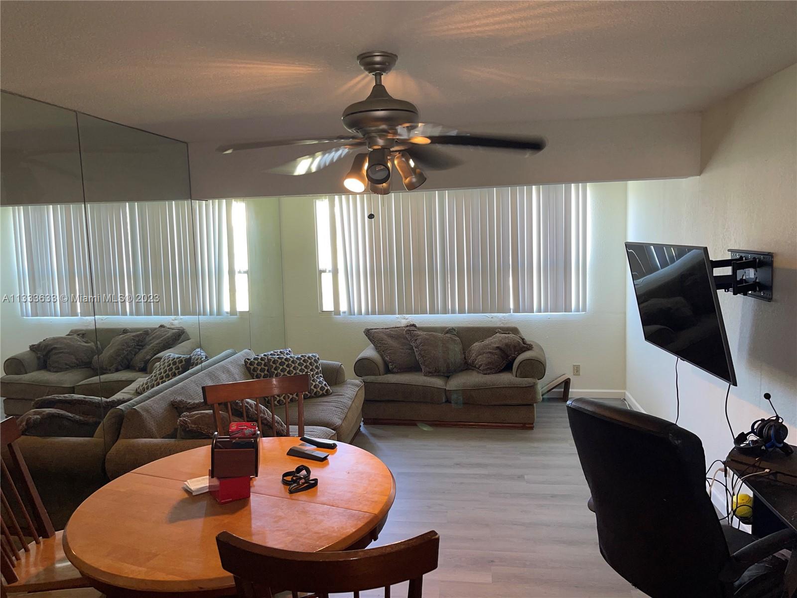 9500 Southwest 3rd Street, Unit C258 Boca Raton, FL 33428 - Photo 5 of 13 a living room with furniture a ceiling fan and a window