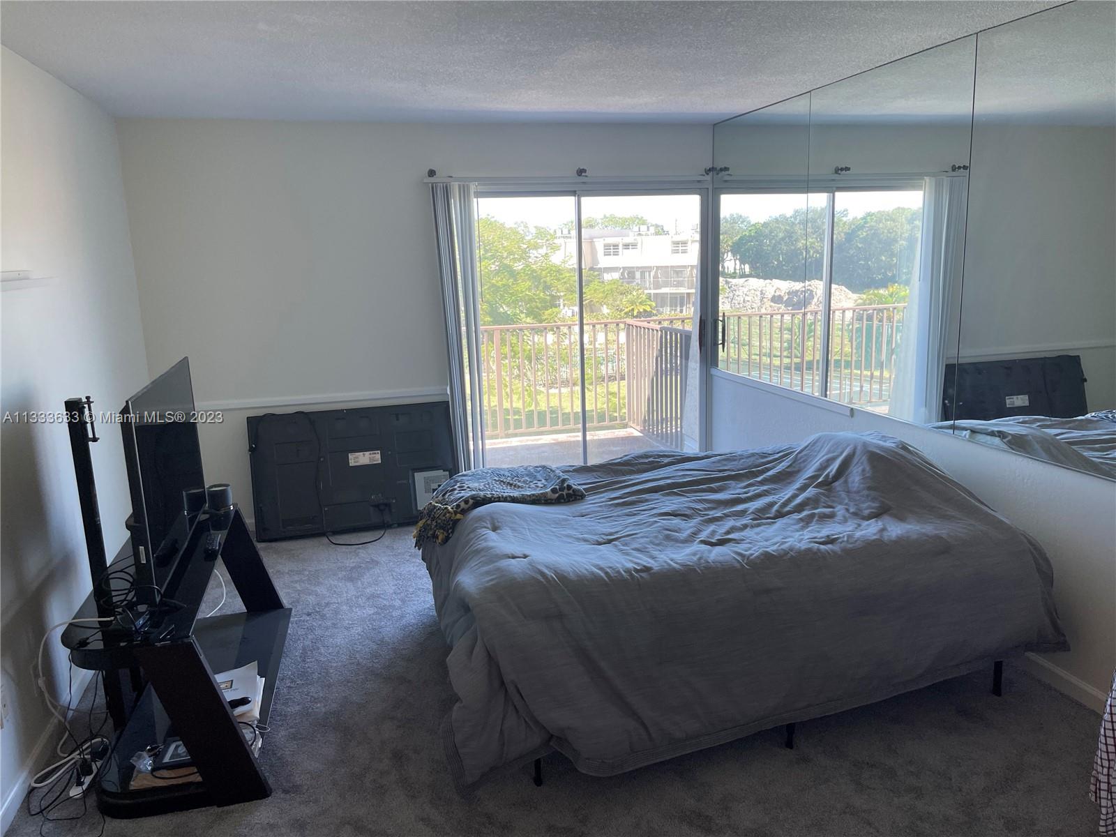 9500 Southwest 3rd Street, Unit C258 Boca Raton, FL 33428 - Photo 8 of 13 a bed sitting in a bedroom next to a window