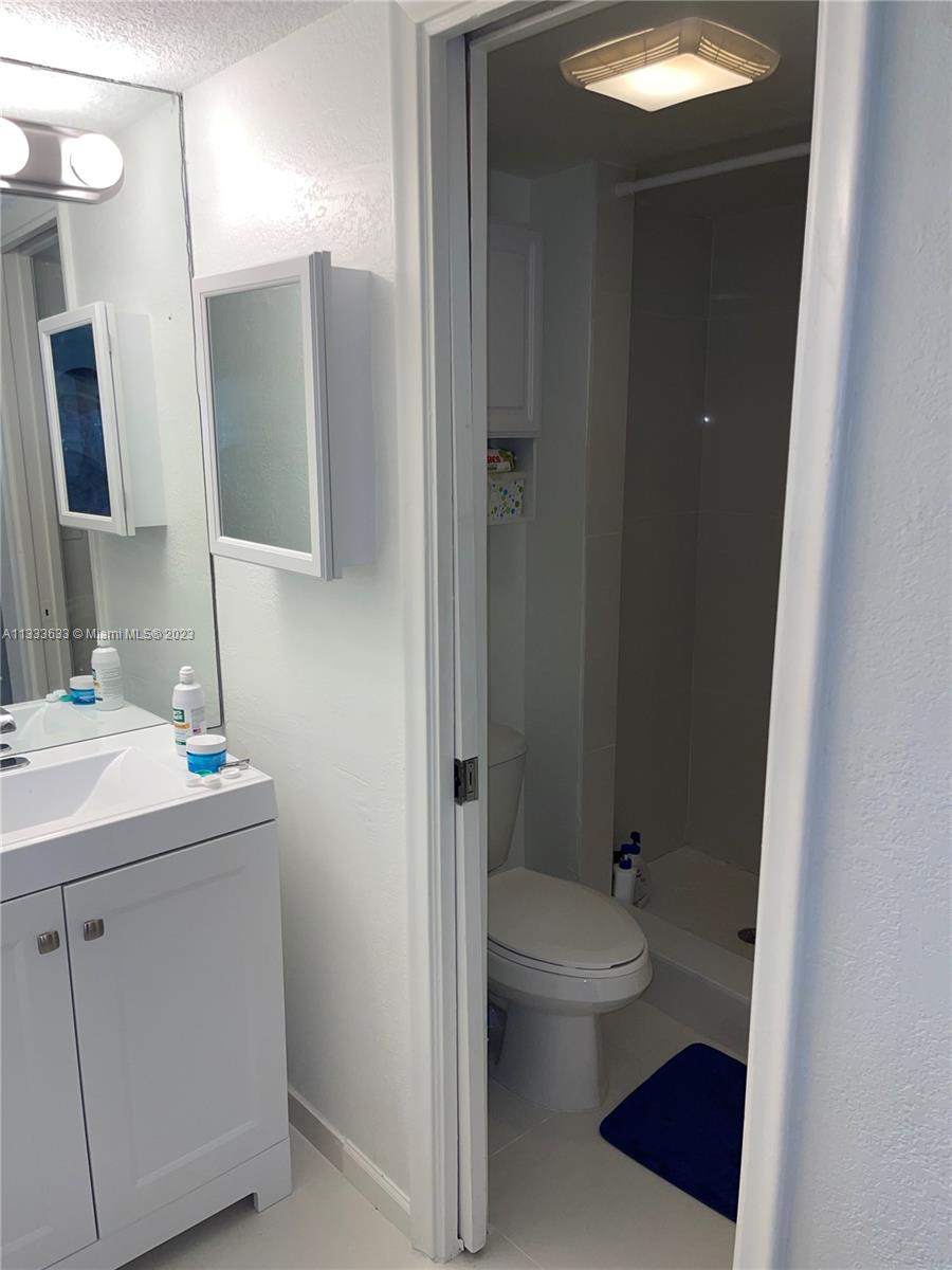 9500 Southwest 3rd Street, Unit C258 Boca Raton, FL 33428 - Photo 9 of 13 a bathroom with a sink a toilet and shower