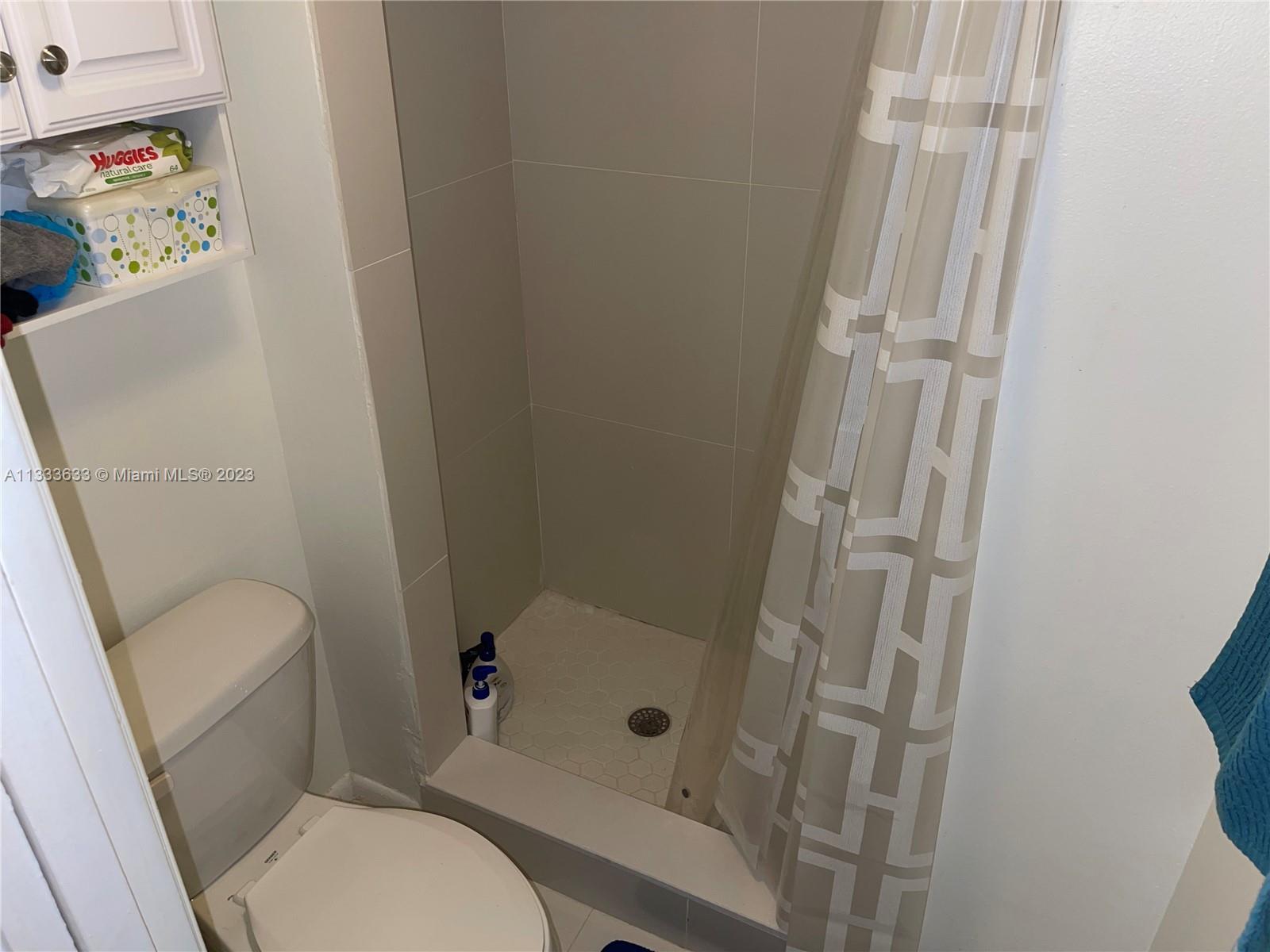 9500 Southwest 3rd Street, Unit C258 Boca Raton, FL 33428 - Photo 10 of 13 a white toilet sitting next to a shower