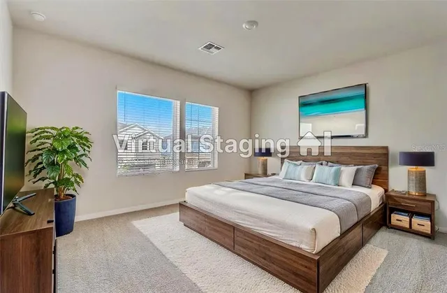 a spacious bedroom with a bed a couch and potted plant