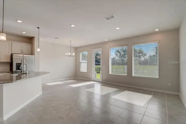 a view of a kitchen with a sink and a large window