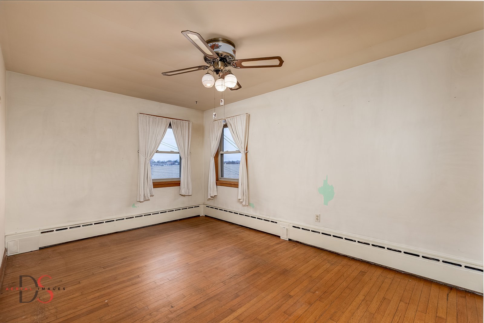 3476 East 27th Road Marseilles, IL 61341 - Photo 22 of 32 an empty room with wooden floor fan and windows
