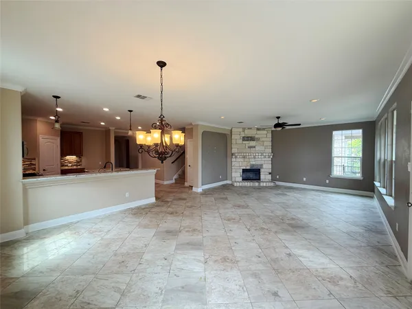 a view of an empty room with a fireplace and a window