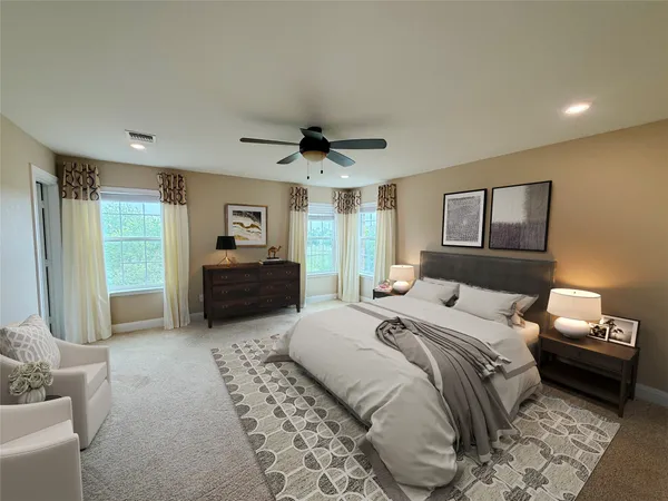 a bedroom with a bed and a couch