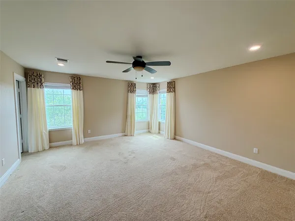 a view of a livingroom with a ceiling fan and window