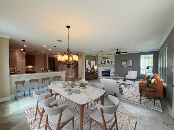 a living room with furniture a table and kitchen view