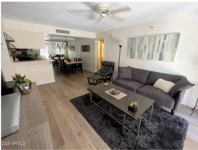 a living room with furniture and wooden floor