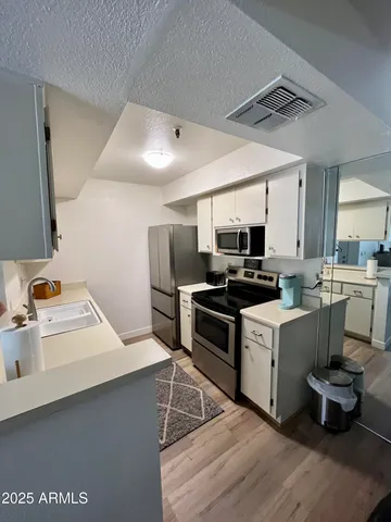 a kitchen with a sink appliances and cabinets