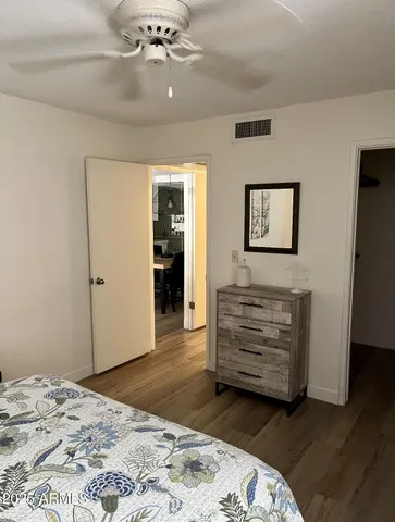 a bedroom with a bed and a dresser