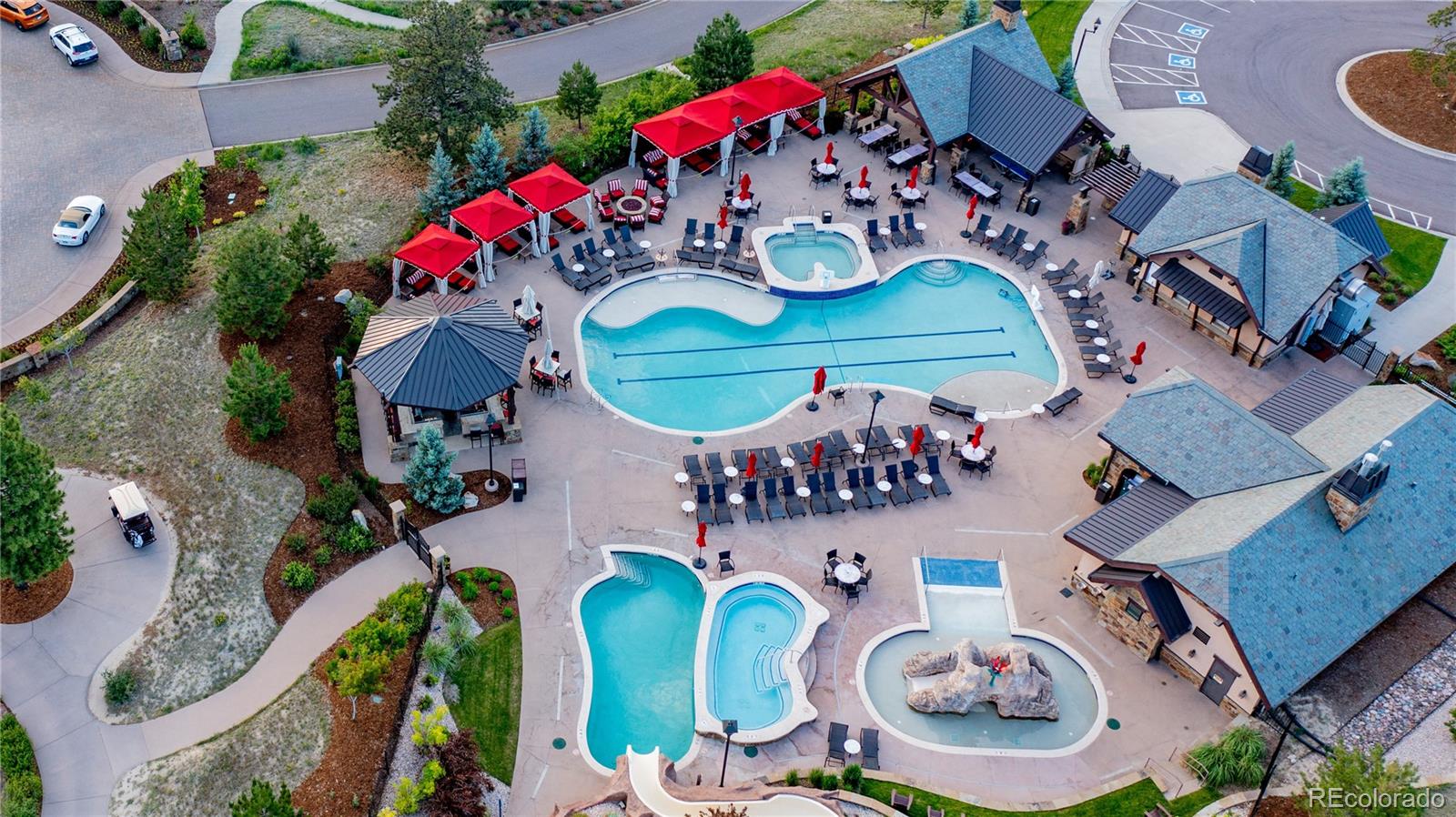 an aerial view of a swimming pool patio kitchen and outdoor seating