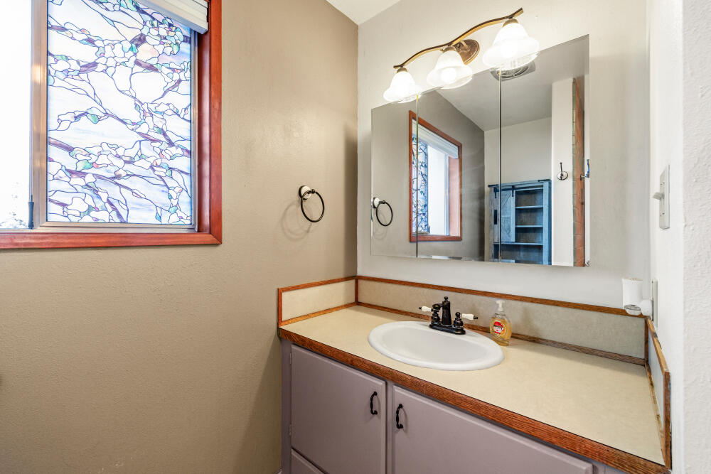 23131 North Poe Valley Road Klamath Falls, OR 97603 - Photo 26 of 45 a bathroom with a sink and a mirror